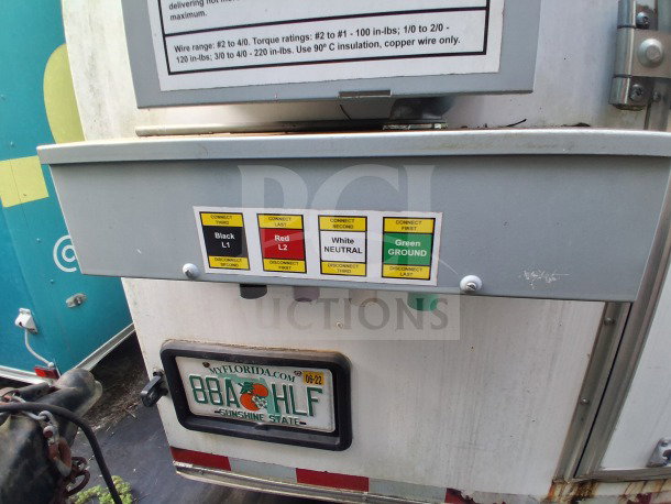 2019 Diamond Cargo 24' mobile kitchen's electrical panel with connection labels and Florida license plate.
