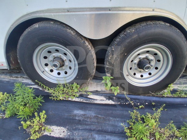 2019 Diamond Cargo 24' mobile kitchen trailer wheels. Dual axle setup, visible wear on tires. Needs a deep clean.