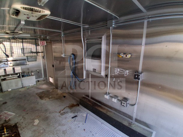 2019 Diamond Cargo 24' mobile kitchen trailer interior, featuring ventilation, wiring, and plumbing; needs deep cleaning.