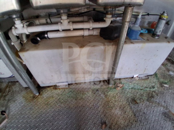 2019 Diamond Cargo 24' mobile kitchen interior, showing plumbing under a sink. Needs deep cleaning. Pro-series features.