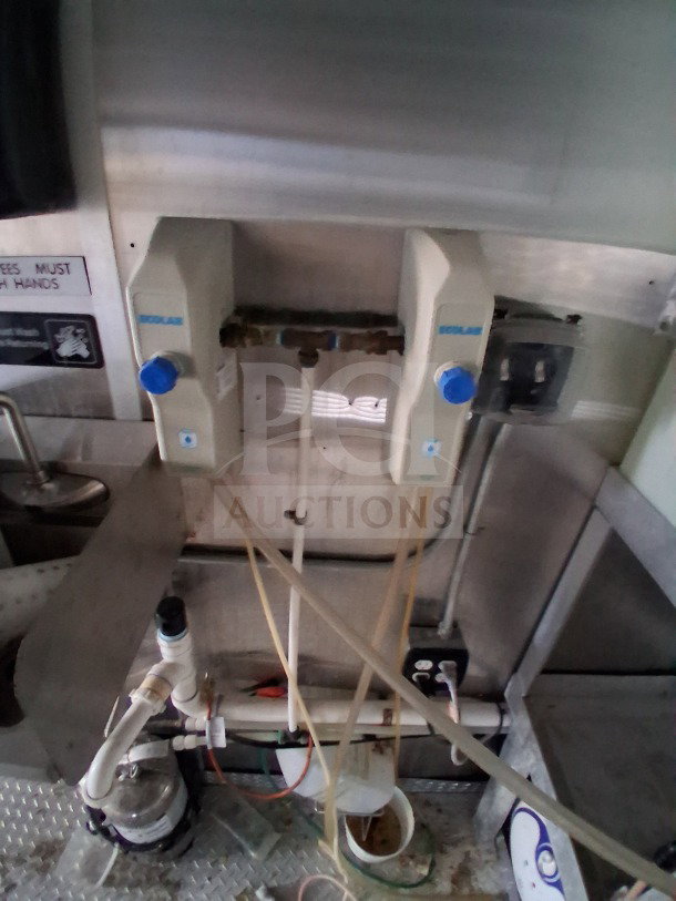 Interior of 2019 Diamond Cargo mobile kitchen showing plumbing system with Ecolab equipment, requiring deep cleaning.