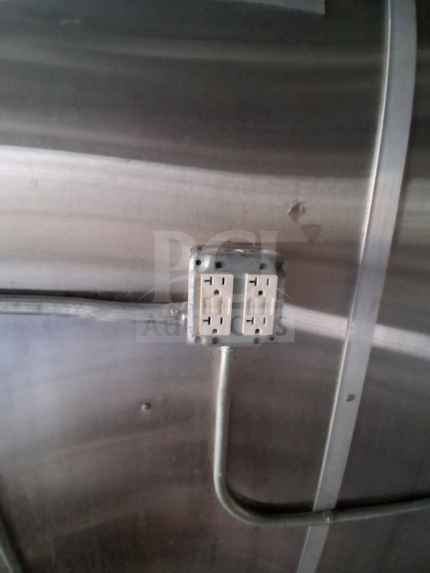 Interior of 2019 Diamond Cargo 24' mobile kitchen showing electrical outlet and conduit on stainless steel wall.