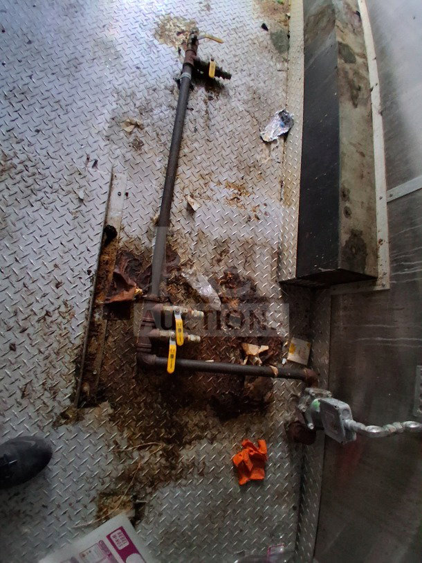 2019 Diamond Cargo 24' mobile kitchen interior showing rusted plumbing and dirty floor, needs deep cleaning. VIN: 53NBE2422m1090404.