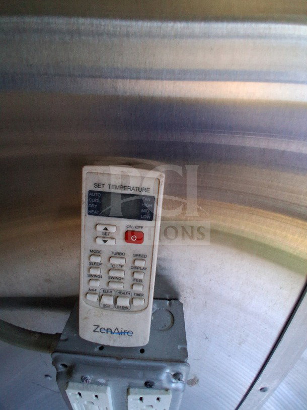 Remote control for ZenAire HVAC system in 2019 Diamond Cargo mobile kitchen. Features include temperature and mode settings.