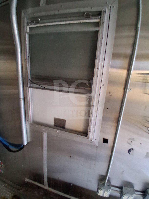 2019 Diamond Cargo 24' mobile kitchen interior with ventilation, metal walls, and electrical wiring; needs deep cleaning.