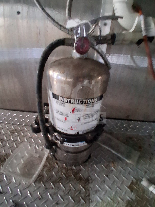 Fire suppression system inside a 2019 Diamond Cargo 24' mobile kitchen. Features instructions label, ready for installation.