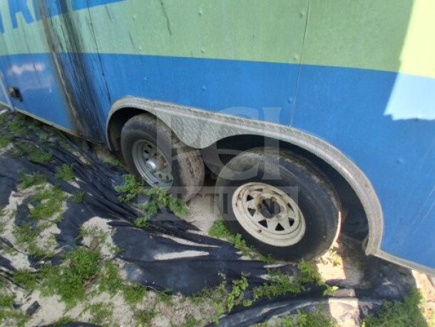 2019 Quality Cargo Food Trailer wheel section. Tires appear worn, side panel shows use. Potential maintenance needed.