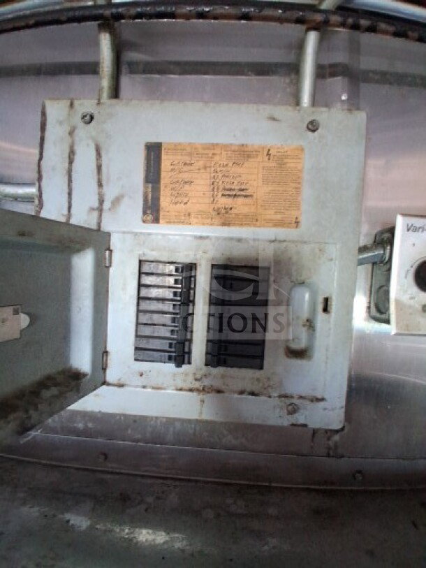 Electrical panel with visible breakers and a label detailing electrical specifications inside a 2019 Quality Cargo Food Trailer.