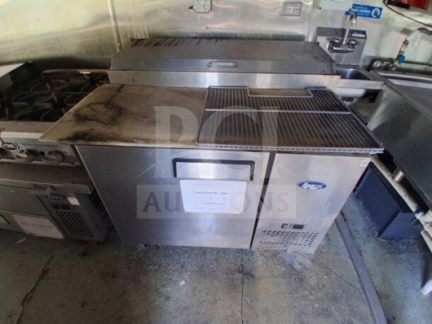 2019 Quality Cargo Food Trailer interior showing a commercial kitchen with grease hood, dual fryers, griddle, burner cooktop, and refrigeration suite.