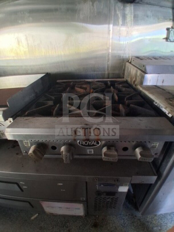 2019 Quality Cargo food trailer kitchen interior, featuring Royal burner cooktop. Visible stainless steel walls and appliances.