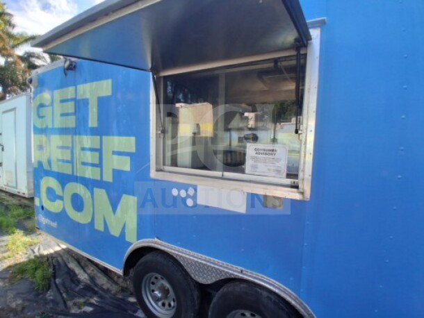 2019 Quality Cargo food trailer, blue exterior, large order window, equipped with grease hood, dual fryers, griddle, burner cooktop, refrigeration suite.