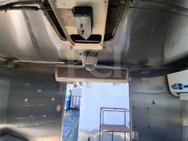 2019 Quality Cargo Food Trailer interior. Features include a grease hood, visible wiring, and vents. Clean metal surfaces.