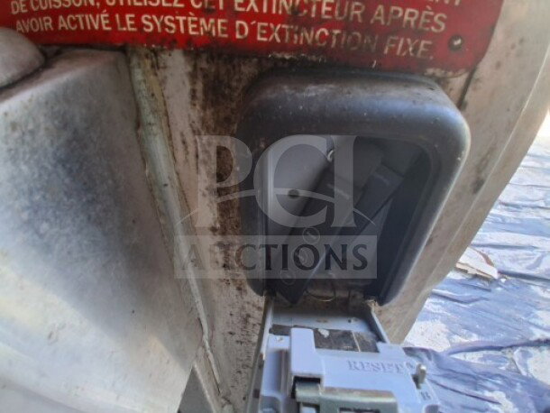 Close-up of a control panel in the 2019 Quality Cargo Food Trailer, showing operational buttons and part of the safety system.