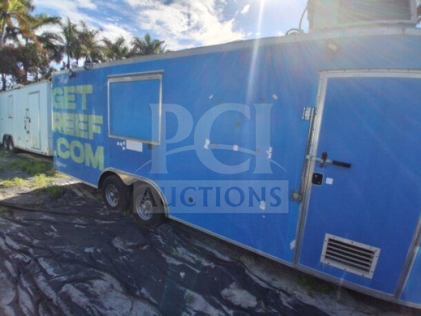 2019 Quality Cargo Food Trailer, blue exterior, large order window, grease hood, fryers, griddle, cooktop, refrigeration.