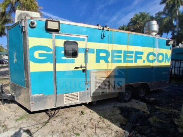 2018 Freedom 20' food trailer with large service window. Equipped with high-performance kitchen, Henny Penny fryer, Ovention oven, refrigeration, and fire suppression system.
