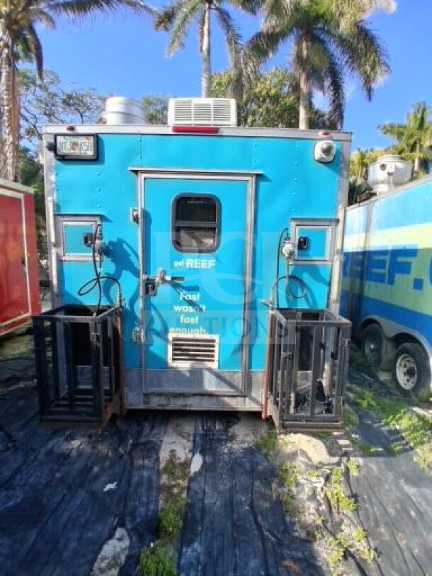 2018 Freedom 20' food trailer with dual-axle, large service window, Henny Penny fryers, Ovention oven, and refrigeration units.