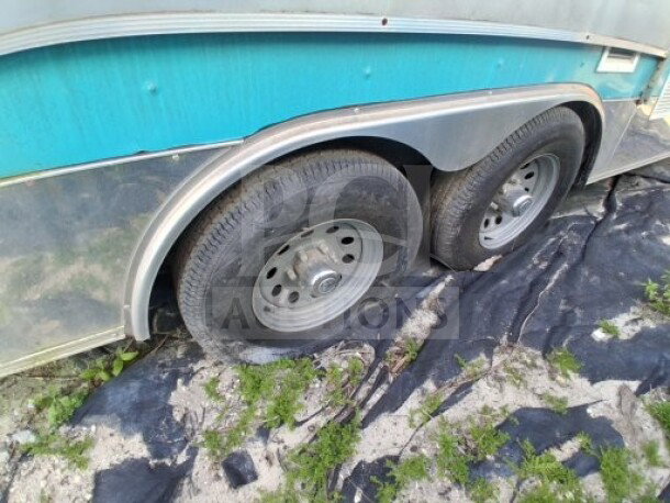 2018 Freedom 20' dual-axle food trailer, blue exterior, visible wheel detail. Ideal for high-volume mobile kitchen use.
