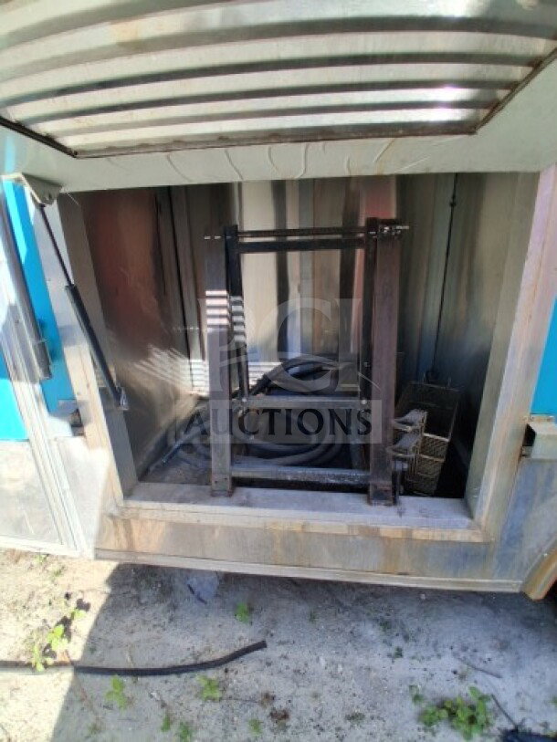 2018 Freedom 20' Food Trailer interior space showing metal frame and plumbing components. Suitable for high-volume service.