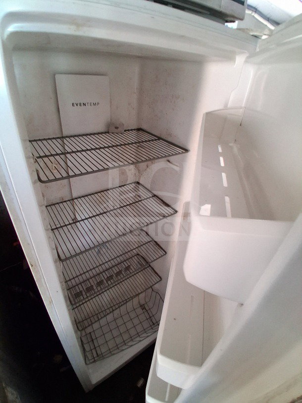 Open commercial refrigerator interior with wire shelves and "EVENTEMP" label inside a 2018 Freedom food trailer.