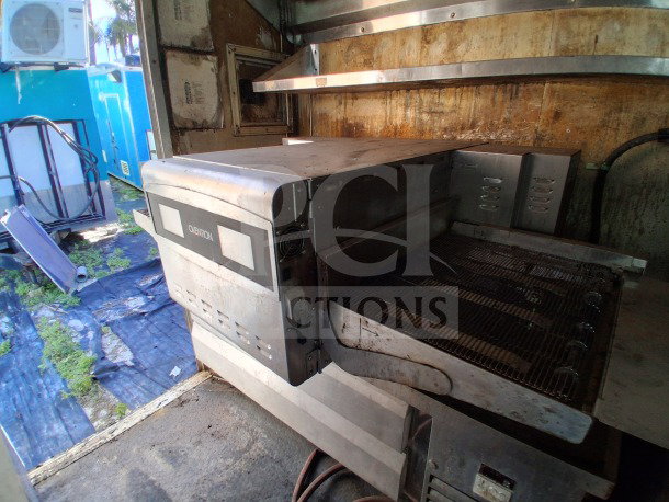 2018 Freedom 20' food trailer interior showing Ovention Pizza oven and Ikon refrigerated chef base.