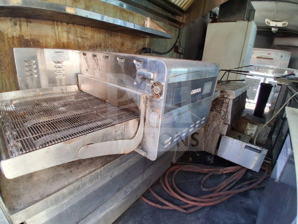 2018 Freedom 20' food trailer with Henny Penny fryer, Ovention pizza oven, Ikon chef base, and full refrigeration setup.