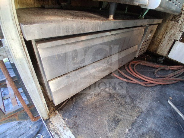 Stainless steel Ikon refrigerated chef base with two drawers, showing signs of wear, in 2018 Freedom food trailer.