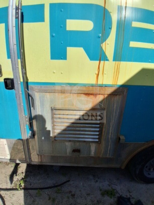 2018 Freedom 20' food trailer exterior with visible vent, showing signs of wear and discoloration, partially shadowed.