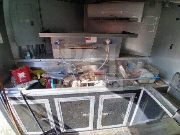 2018 Freedom 20' food trailer interior, showing professional-grade kitchen setup with sink, prep areas, and storage.