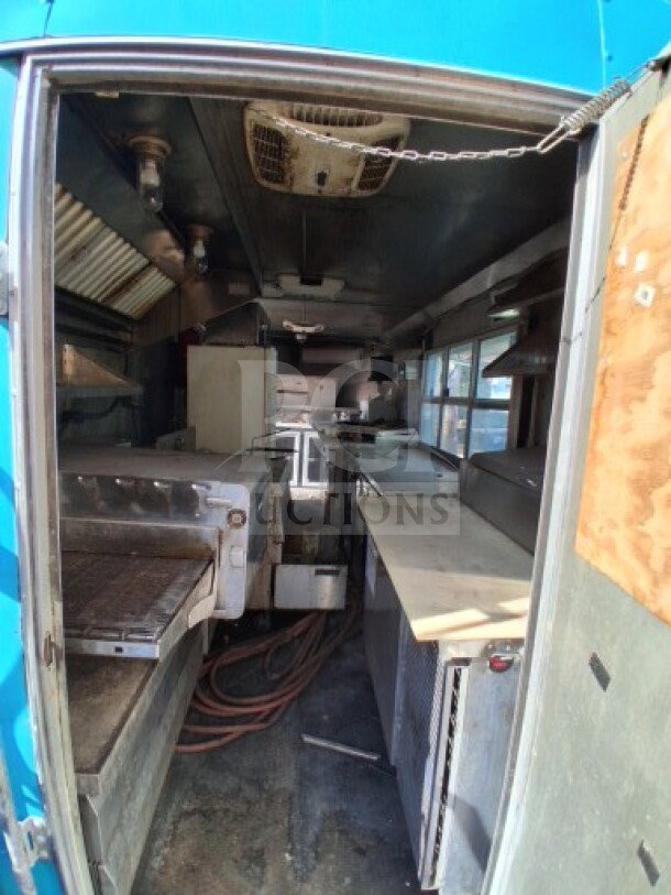 2018 Freedom 20' Food Trailer interior; features Henny Penny fryer, Ovention oven, refrigeration units, and commercial exhaust.