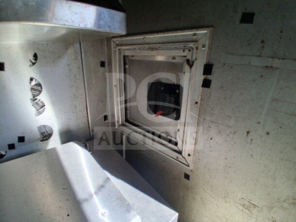 Metal interior of 2018 Freedom 20' Food Trailer, showing a compartment door and vent, highlighting durable construction.