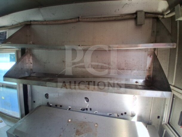 2018 Freedom 20' food trailer interior shelves, stainless steel, storage for kitchen items. Ideal for high-volume food service.