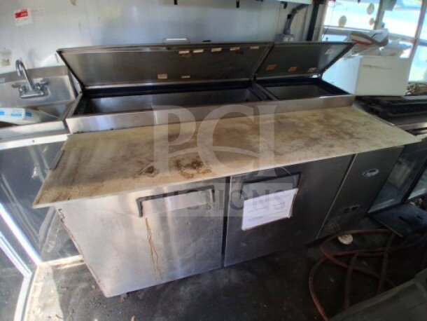2018 Freedom 20' Food Trailer interior with Ikon refrigerated chef base. Stainless steel surface, visible wear.