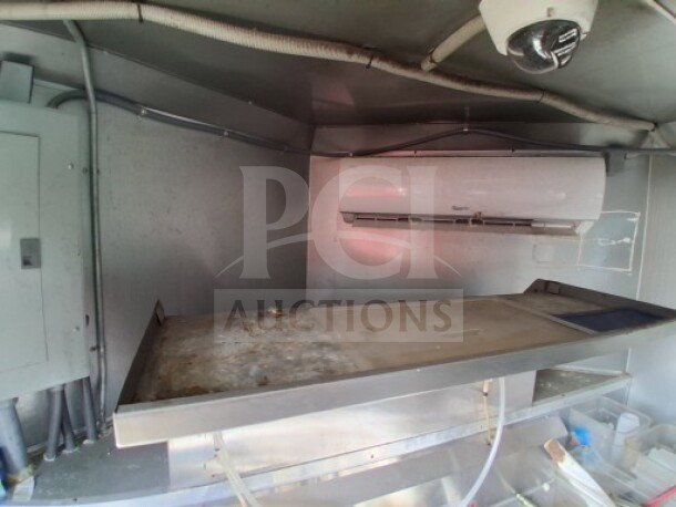 2018 Freedom 20' food trailer interior with refrigeration unit, showing professional kitchen setup for high-volume use.