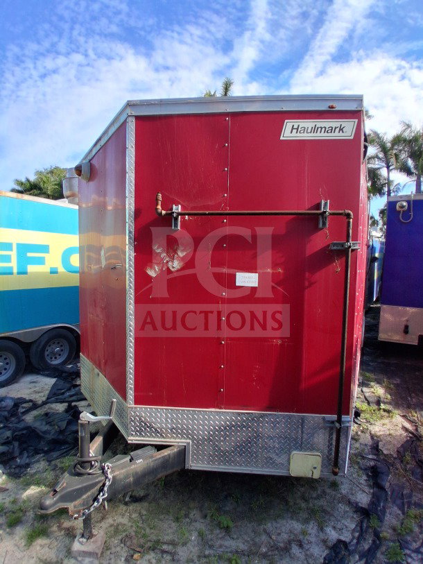 2021 Haulmark 8.5' x 24' Mobile Kitchen Trailer, red exterior, dual-axle, Haulmark logo visible. VIN: 7KB1E2426MT000363.