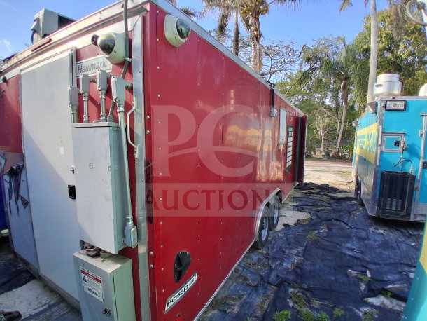 2021 Haulmark 8.5' x 24' mobile kitchen trailer, red exterior, dual-axle. Features large refrigeration units and exhaust hood.