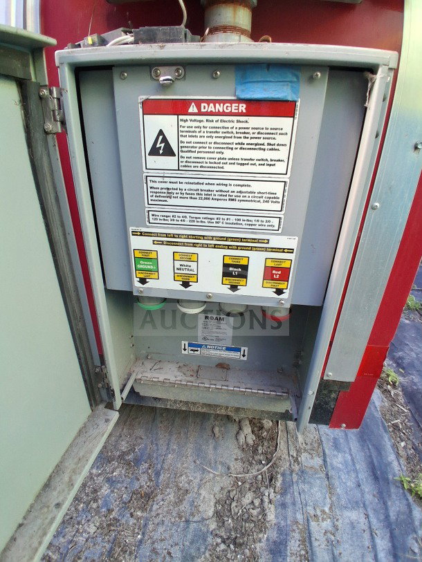 Electrical panel in open compartment of 2021 Haulmark mobile kitchen trailer with danger warning labels and wiring instructions.