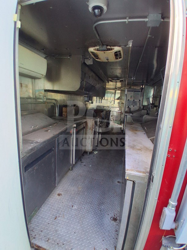 2021 Haulmark 8.5' x 24' dual-axle mobile kitchen trailer interior, featuring a commercial exhaust hood, Arctic Air refrigeration suite, and three-compartment sink, ready for high-volume culinary operations.