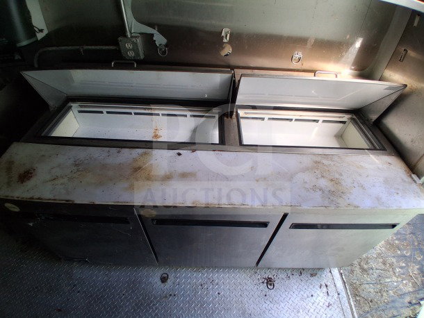2021 Haulmark 8.5' x 24' Mobile Kitchen Trailer interior, featuring dual Arctic Air refrigeration units. Visible wear on surfaces.
