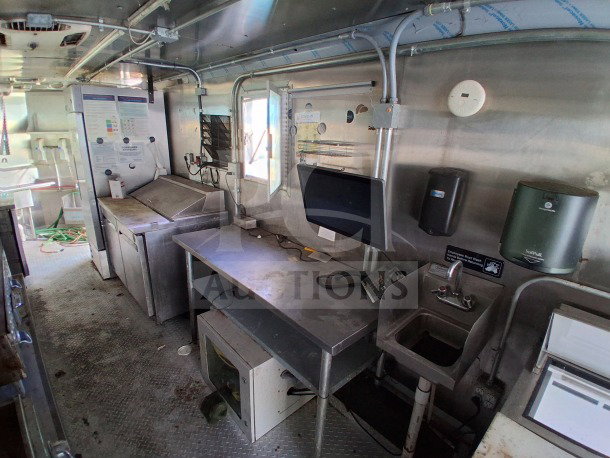 2021 Haulmark 8.5' x 24' mobile kitchen trailer interior, featuring Arctic Air refrigeration, commercial exhaust hood, sinks, and workstations.
