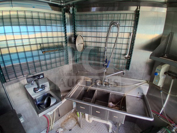 2021 Haulmark 8.5' x 24' mobile kitchen trailer interior with three-compartment sink, secondary sink, and high-efficiency setup.