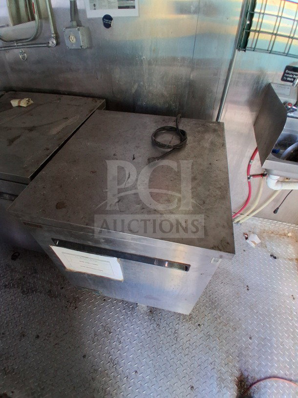 2021 Haulmark mobile kitchen trailer interior, stainless steel surfaces, Arctic Air refrigeration unit, and sanitation sink.