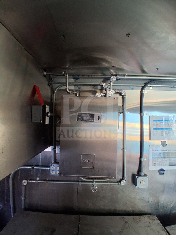 2021 Haulmark 8.5' x 24' mobile kitchen trailer featuring commercial exhaust hood and fire suppression system interior.