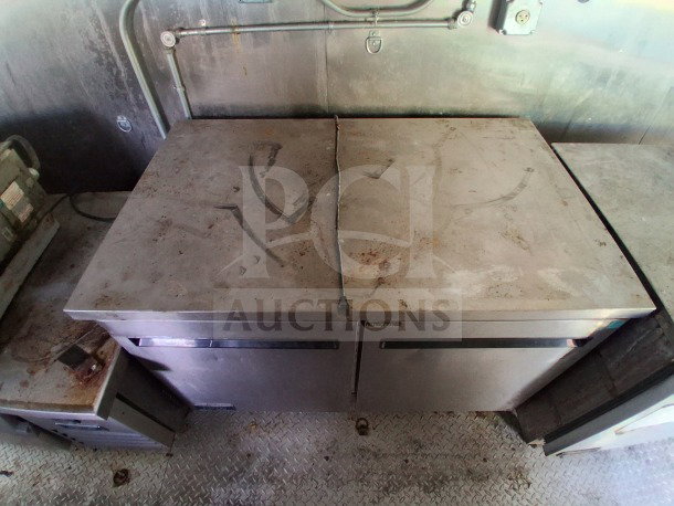 2021 Haulmark Mobile Kitchen Trailer interior with Arctic Air refrigeration units, showing signs of use, ready for deployment.