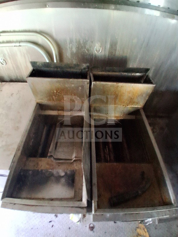 Interior of 2021 Haulmark Mobile Kitchen Trailer showing used fryer compartments with visible wear.