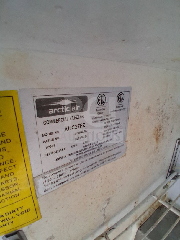 Close-up of Arctic Air commercial freezer label, model AUC27FZ, showing specifications and certifications.