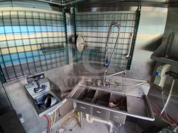 2021 Haulmark mobile kitchen trailer interior with three-compartment sink, sanitation sink, and commercial fixtures.