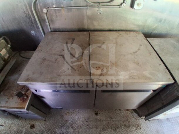 2021 Haulmark 8.5' x 24' mobile kitchen trailer interior; Arctic Air refrigeration units, dual-axle, commercial exhaust hood.