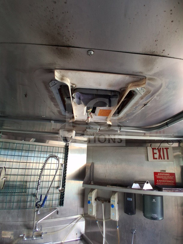 Interior of 2021 Haulmark 8.5' x 24' Mobile Kitchen Trailer showing sanitation sink, Arctic Air refrigeration, and exhaust hood.