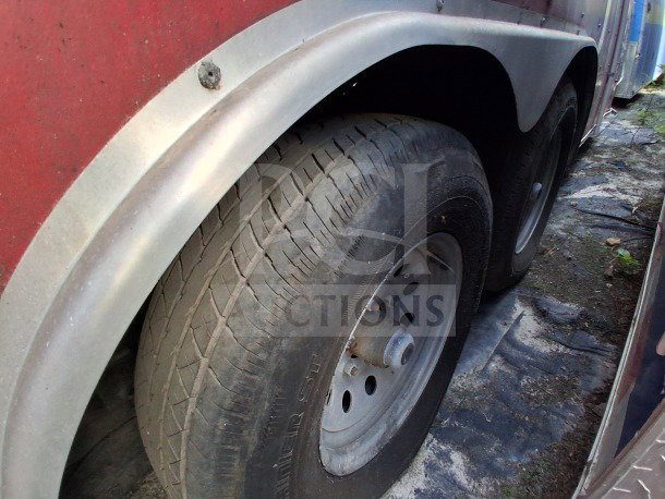 2021 Haulmark 8.5' x 24' dual-axle mobile kitchen trailer tire and fender, showcasing sturdy build and condition.