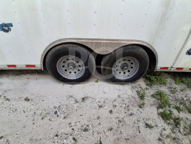 Dual axle of 2021 Diamond Cargo 24' Custom Mobile Kitchen, white exterior, suitable for high-volume service events.